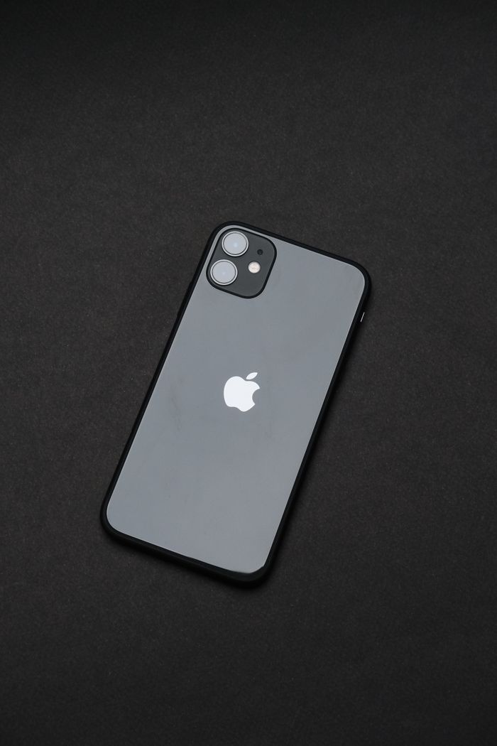 services-04 An elegant smartphone on a dark background, emphasizing modern tech design.