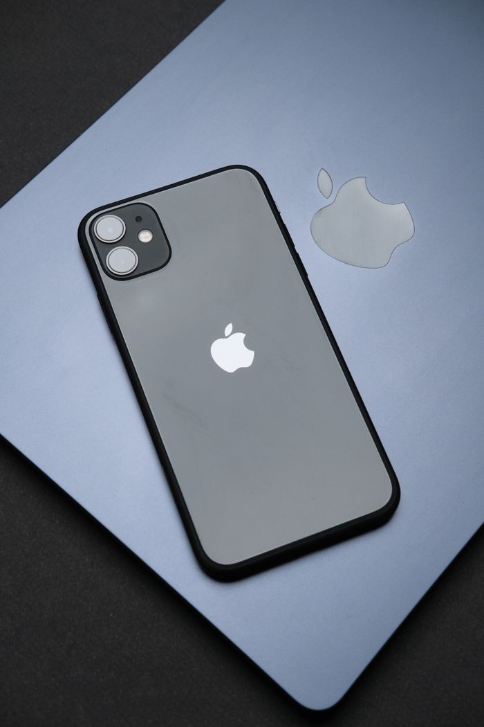 services-01 Stylish Apple iPhone on a MacBook, showcasing modern technology and design.